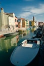 Vibrant houses along a boat lined canal in Burano, Venice, Italy - nov, 2021 Royalty Free Stock Photo