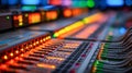 Vibrant illuminated audio mixing console with multicolored control buttons and connected cables in modern music production studio Royalty Free Stock Photo