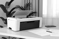 Modern printer on a white desk in an office setting Royalty Free Stock Photo