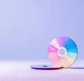 This vibrant image features colorful CDs placed against a soft purple background, symbolizing music, data storage, and the Royalty Free Stock Photo
