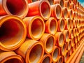 Stacked Orange Concrete Boom Pipes at an Industrial Construction Site A Vibrant Stock Photo of Construction Materials Royalty Free Stock Photo