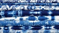 Vibrant indigo batik fabrics with traditional white patterns Royalty Free Stock Photo