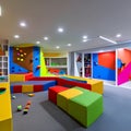 A vibrant and interactive playroom with a climbing wall, a slide, and a play kitchen2, Generative AI