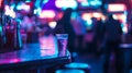 Vibrant interior of an arcade bar at night neon lights, blurred motion, and drinks on a table Royalty Free Stock Photo