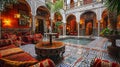 Vibrant interior of a traditional Marrakech riad, showcasing ornate tile work, richly colored fabrics, and a central courtyard Royalty Free Stock Photo