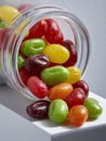 Vibrant jellybeans spilling from a jar, colorful and appetizing. Royalty Free Stock Photo