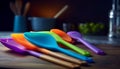 Vibrant kitchenware collection colorful spoons, spatula, bowl generated by AI Royalty Free Stock Photo