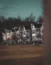 Vibrant landscape featuring multiple residential buildings set in a vast grassy field Royalty Free Stock Photo