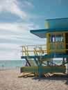 Vibrant lifeguard tower on a beach with pristine white sand stretching out to a calm blue ocean Royalty Free Stock Photo