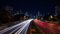 Vibrant light trails streaking through cityscape at night Royalty Free Stock Photo
