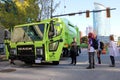 Vibrant lime green pickup truck is idling at a stoplight with people inside the cab