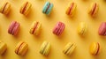 Colorful macarons arranged in a grid pattern on a yellow background. Bright and cheerful design for culinary projects Royalty Free Stock Photo