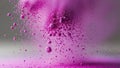 Vibrant magenta colored powder exploding dynamically against gradient gray to purple background creating colorful dust cloud Royalty Free Stock Photo