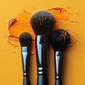 Vibrant makeup brushes scattered on an orange canvas.