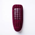 Vibrant Maroon Knitted Remote In Minimalist White Background Photography