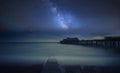 Vibrant Milky Way composite image over landscape of Long exposure of ruined pier at sea Royalty Free Stock Photo