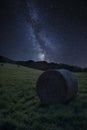 Vibrant Milky Way composite image over landscape of Summer countryside of field with hay bales Royalty Free Stock Photo