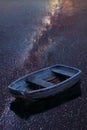 Vibrant Milky Way composite image of single rowing boat floating