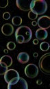 Iridescent Bubbles Floating Against a Dark Black Background Royalty Free Stock Photo