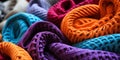 Vibrant multicolored crocheted blankets in a close up view showcasing textures and patterns in a cozy intertwined heap Royalty Free Stock Photo