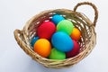 Vibrant multicolored Easter eggs in a wicker basket