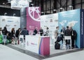 Vibrant networking at Fitur 2024: Tourism professionals engage amidst colorful displays