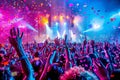 Vibrant night club energetic rock concert with cheering crowd, stage lights, and falling confetti Royalty Free Stock Photo