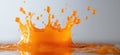 Vibrant orange liquid splash creating dynamic droplets against a soft background Royalty Free Stock Photo