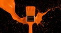 A vibrant orange paintbrush colliding with a splash of paint against a stark black backdrop Royalty Free Stock Photo