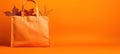 Vibrant orange shopping bag on a yellow background a colorful, eco friendly concept. Perfect for advertising your retail products