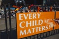 Vibrant orange sign with bold black text reading 'Every Child Matters'