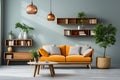 Vibrant orange sofa near blue wall with wooden cabinet and shelves. Scandinavian interior design of modern stylish living room. Royalty Free Stock Photo