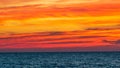 vibrant orange sunset sky and clouds over ocean Royalty Free Stock Photo