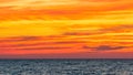 vibrant orange sunset sky and clouds over ocean Royalty Free Stock Photo