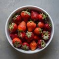 Vibrant Organic Strawberries White Dish on Muted Gray Background Royalty Free Stock Photo