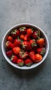 Vibrant Organic Strawberries White Dish on Muted Gray Background Royalty Free Stock Photo