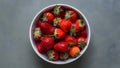 Vibrant Organic Strawberries White Dish on Muted Gray Background Royalty Free Stock Photo