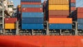 Vibrant painted container ship hull with colorful cargo containers casting long shadows Royalty Free Stock Photo