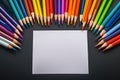 Vibrant palette Multi colored pencils and white paper on elegant black backdrop
