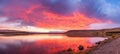 Vibrant panoramic sunset sky over a picturesque natural landscape with beautiful colors and clouds Royalty Free Stock Photo