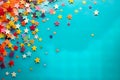 vibrant paper stars and colorful confetti, arranged on a solid color background, creating a joyful and cheerful atmosphere. Royalty Free Stock Photo