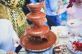 Vibrant Picture of Chocolate Fountain Fontain on childen kids birthday party with a kids playing around and marshmallows and fruit