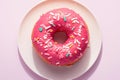 Vibrant pink donut adorned with delicate white sprinkles. Royalty Free Stock Photo