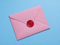 A vibrant pink envelope with a red lining and red wax seal, open on a blue background - AI-Generated Royalty Free Stock Photo