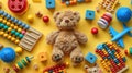 Colorful Baby Toy Collection with Teddy Bear, Abacus, Musical & Fidget Toys and Blocks on Yellow Background - Top View Flat Lay