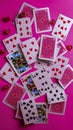 Vibrant Playing Card and Dice Arrangement on Pink Background A Dynamic Display of Gaming Elements
