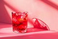 Pomegranate cocktail on pink background