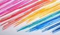 A vibrant rainbow of colored pencil strokes creates an abstract, textured background on white paper. Royalty Free Stock Photo