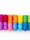 Colorful Thread Spools Arranged on White Vibrant rainbow colored thread spools craft supplies needlework textile art DIY Royalty Free Stock Photo
