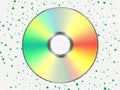 Vibrant rainbow-hued cd on green polka-dotted background Royalty Free Stock Photo